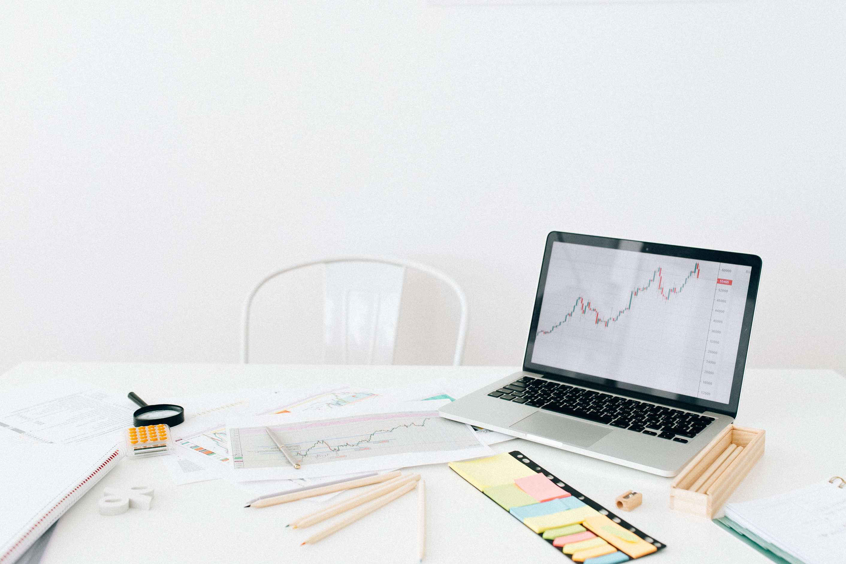 Overhead view of desk with laptop and financial papers